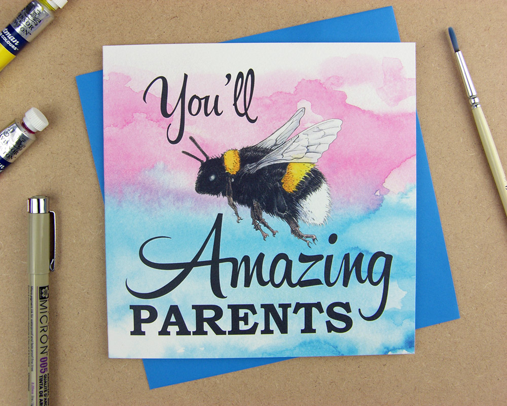 Greetings card with the words 'You'll be amazing parents' with the word 'be' replaced with an illustrated bumblebee on pink watercolour background