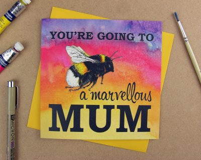Greetings card with the words 'You're going to be a marvellous Mum' with the word 'be' replaced with an illustrated bumblebee on pink watercolour background