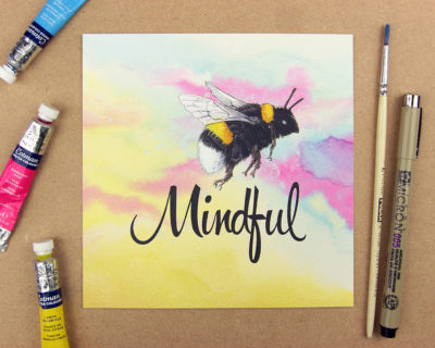 Print showing a bumblebee above the word 'mindful' on yellow and pink watercolour background. Forming the phrase Be mindful.
